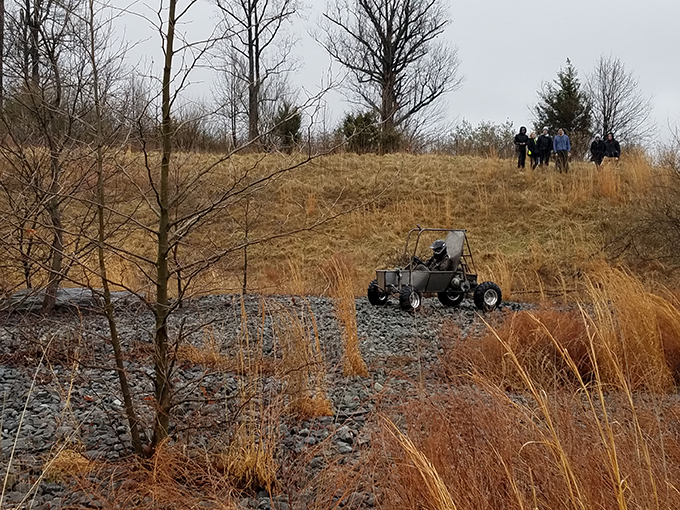 Baja vehicle being driven down a hill at GW's VSTC Campus