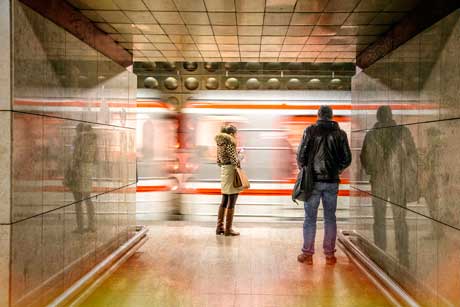 Photograph of two people in a subway station