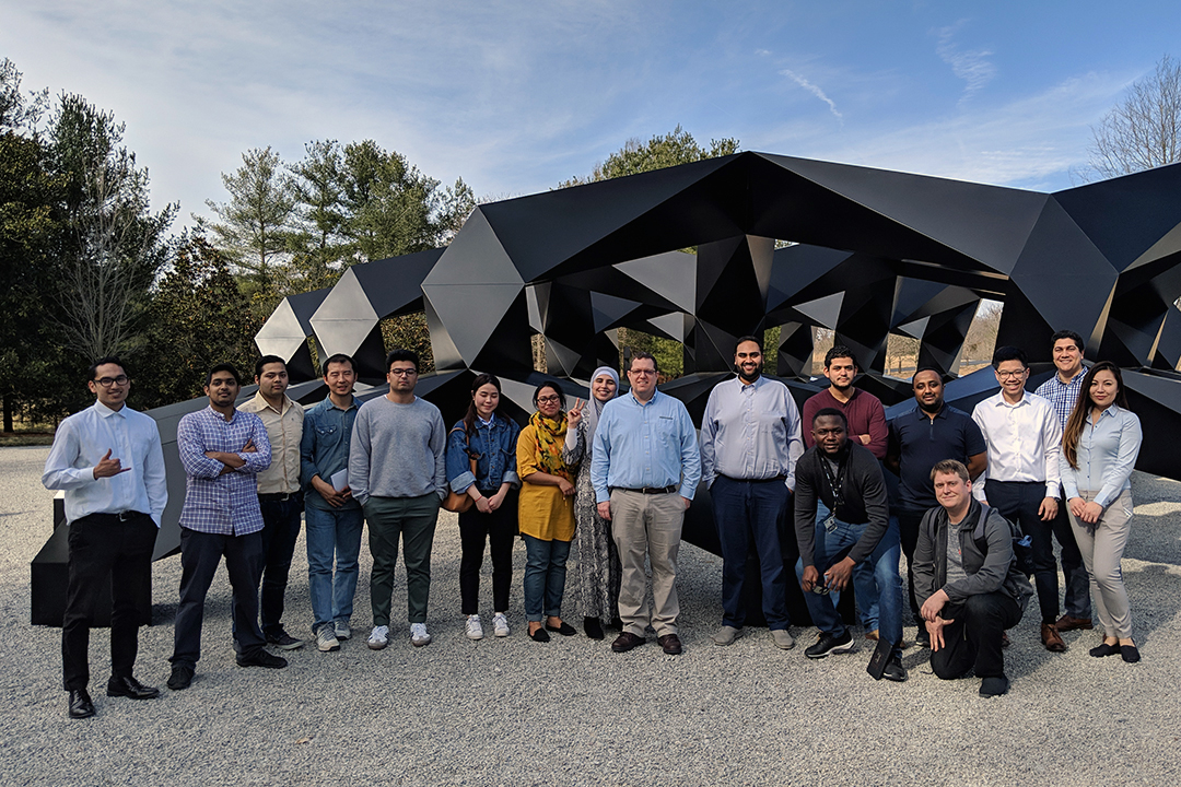 A group of IIST bachelor’s degree completion program students in front of a sculpture at Glenstone art museum