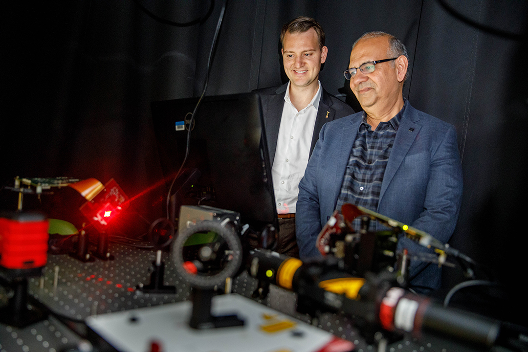 Two researchers look at data processing equipment