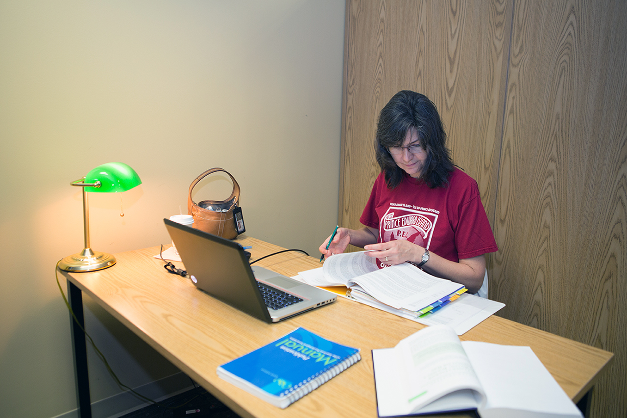 Woman studying in the library at a table