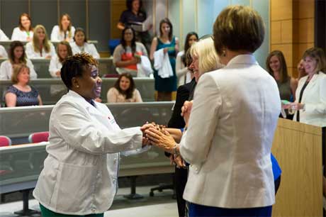 Nursing student shakes dean's hand