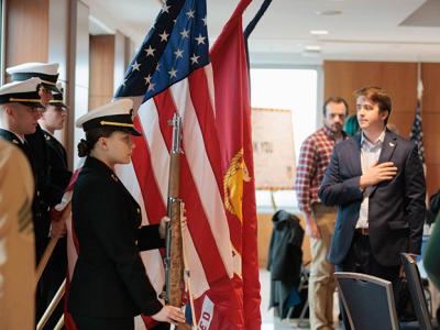 Veteran's Day event with US flag and students