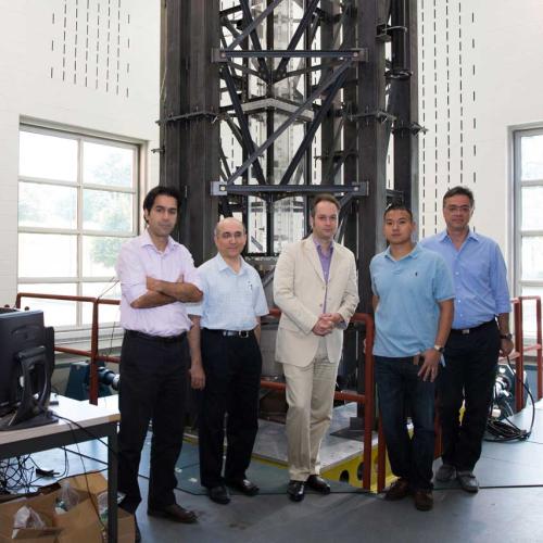 5 person research team stands together for a photo